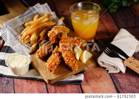 A hearty crispy chicken set with fries and juice A hearty crispy chicken set with fries and juice 81782303