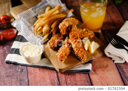 A hearty crispy chicken set with fries and juice A hearty crispy chicken set with fries and juice 81782304