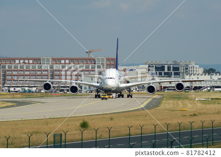 FRANKFURT, GERMANY - JUN 09th, 2017: Airbus A380 of Lufthansa with registration D-AIMH moves on taxiway by tow truck before departure from FRA airport FRANKFURT, GERMANY - JUN 09th, 2017: Airbus A380 of Lufthansa with registration D-AIMH moves on taxiway by tow truck before departure from FRA airport 81782412
