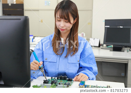Female engineer working with a soldering iron 2 81783273