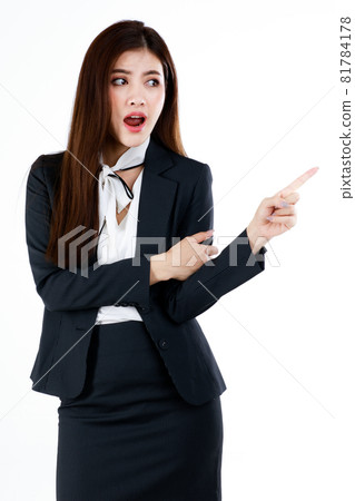 Portrait of young Asian businesswoman in formal suit posing and pointing finger to blank space for present or demonstrate goods or product in advertising gesture, studio shot on white background 81784178