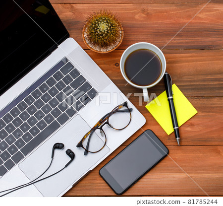 Topview or top down shot of laptop notebook computer with with black coffee in white cup on wood background with copy space. Business idea and creative working concept 81785244
