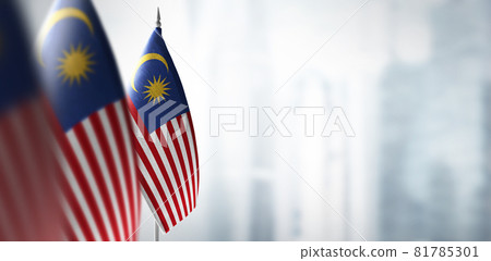 Small flags of Malaysia on a blurry background of the city 81785301