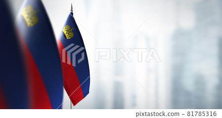 Small flags of Liechtenstein on a blurry background of the city Small flags of Liechtenstein on a blurry background of the city 81785316