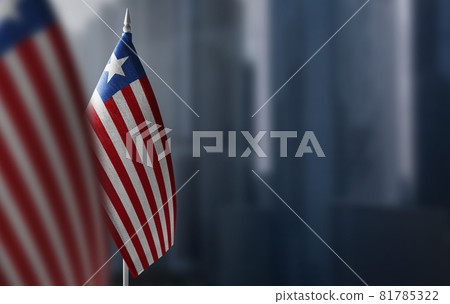 Small flags of Liberia on a blurry background of the city Small flags of Liberia on a blurry background of the city 81785322