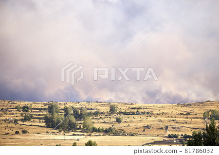 Dark and dense smoke clouds from a fire in Spain. Close-up of a large smoke cloud in the sky from a forest fire 81786032