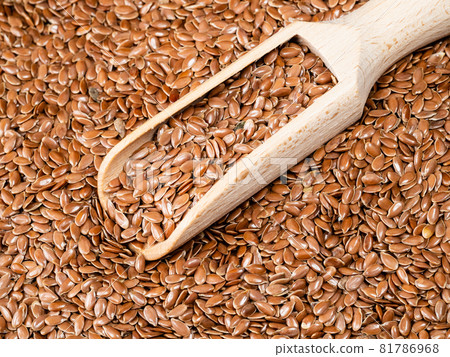 wooden scoop in brown flax seeds close up wooden scoop in brown flax seeds close up 81786968