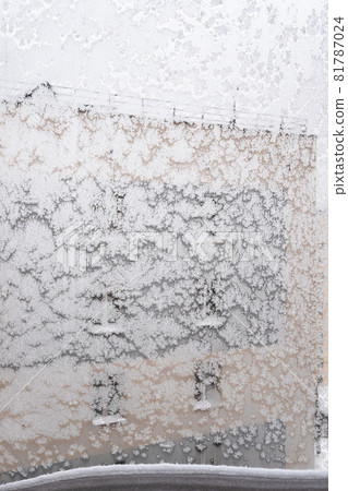frosty home window with snowbank on frame in urban house on overcast winter day (focus on the surface on windowpane) frosty home window with snowbank on frame in urban house on overcast winter day (focus on the surface on windowpane) 81787024