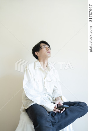 Portrait of a man looking at his smartphone Portrait of a man looking at his smartphone 81787647