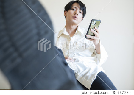 一個男人看著智慧型手機的肖像 81787781