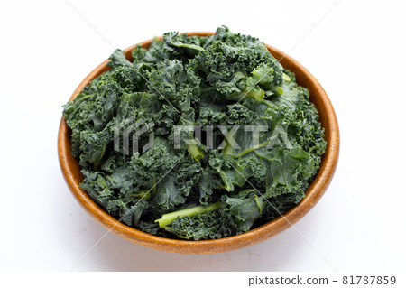Kale leaves in wooden bowl on white background. Kale leaves in wooden bowl on white background. 81787859