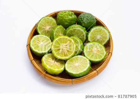 Bergamot kaffir lime in bamboo basket on white Bergamot kaffir lime in bamboo basket on white 81787905