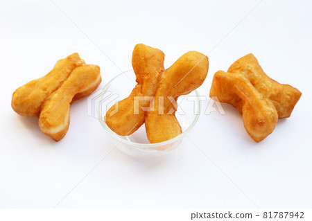Deep-fried dough sticks or chinese bread sticks on white background. Deep-fried dough sticks or chinese bread sticks on white background. 81787942
