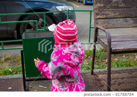 adorable kid throws trash in a street bin adorable kid throws trash in a street bin 81788784