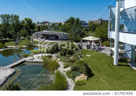 Green courtyard of country house with artificial pond, patio area and playground Green courtyard of country house with artificial pond, patio area and playground 81791499