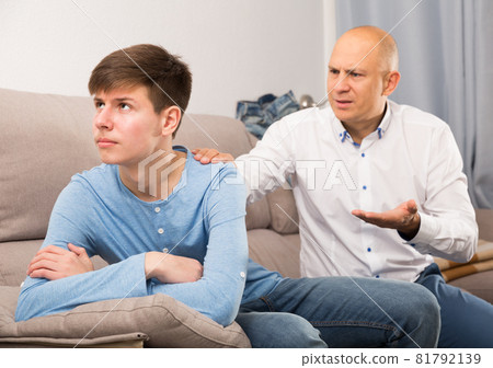 Father scolding his turned away son 81792139