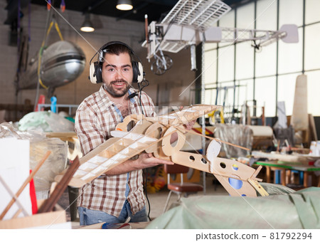Man in pilot headsets with plane models 81792294