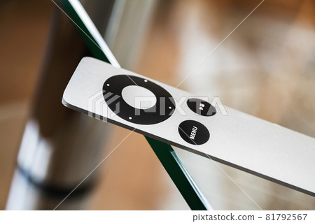 The modern grey steel Remote Control lies on a glass table. Closeup, selective focus The modern grey steel Remote Control lies on a glass table. Closeup, selective focus 81792567