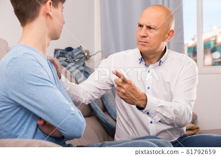 Strict father talking to son Strict father talking to son 81792659