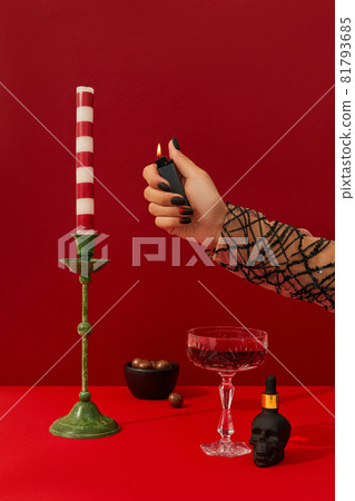 Womans hand with spooky nail design set the table. Halloween cocktail on red background 81793685