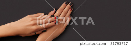 Manicured female hands with fashion accessories on black. Trendy autumn halloween bloody spooky nail design. Manicured female hands with fashion accessories on black. Trendy autumn halloween bloody spooky nail design. 81793717