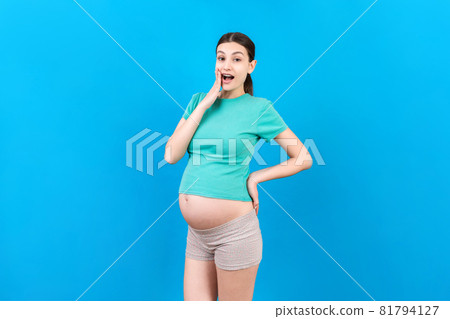 Young surprise or shocked woman pregnant isolated colored background. expression female 81794127