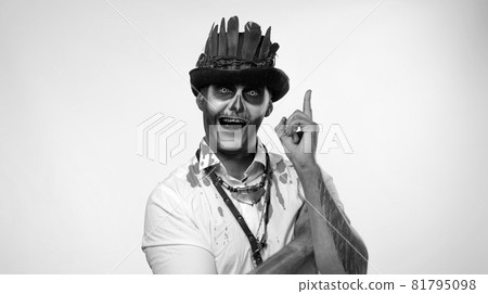 Creepy man with skeleton makeup considering serious plan, solving problem in mind, smart idea 81795098