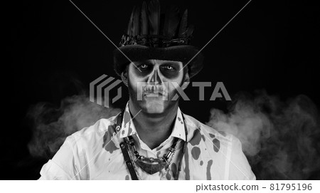 Sinister man with Halloween skeleton makeup in shirt with blood looking at camera, trying to scare Sinister man with Halloween skeleton makeup in shirt with blood looking at camera, trying to scare 81795196