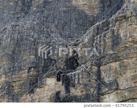 Climbing under the rain in three peaks of Lavaredo valley dolomites mountains 81795253