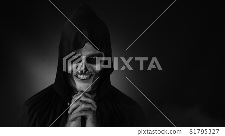 Creepy, crazy man with skeleton makeup in hood making angry faces, shaking head, trying to scare Creepy, crazy man with skeleton makeup in hood making angry faces, shaking head, trying to scare 81795327