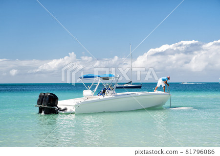 man, yachtsman on motorboat on water, in St. John, Antigua 81796086