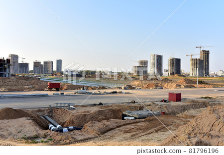 Laying heating pipes in trench at construction site. Laying heating pipes in trench at construction site. 81796196