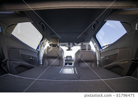 empty trunk of a modern car with folded rear seats. large interior volume. trunk view 81796475