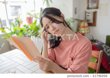 A young woman worried about seeing an envelope A young woman worried about seeing an envelope 81796898
