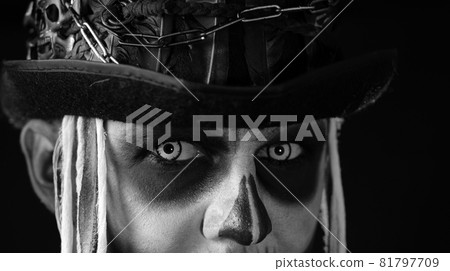Close-up shot of creepy man in skeleton Halloween makeup opening eyes and looking spooky at camera 81797709