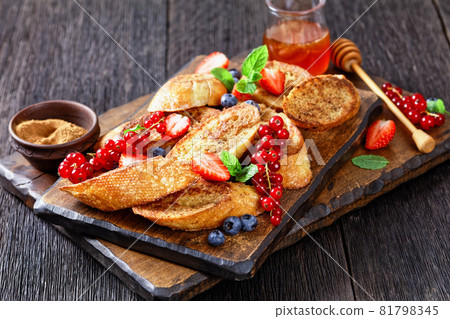 crispy sweet toasts with fresh berries and honey crispy sweet toasts with fresh berries and honey 81798345