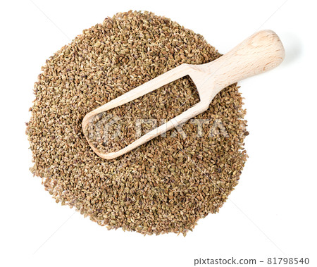 top view of wood scoop on pile of ajowan fruits on white background 81798540