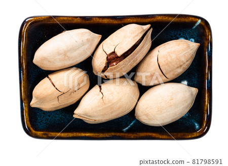top view of unshelled pecan nuts in bowl cutout on white background top view of unshelled pecan nuts in bowl cutout on white background 81798591