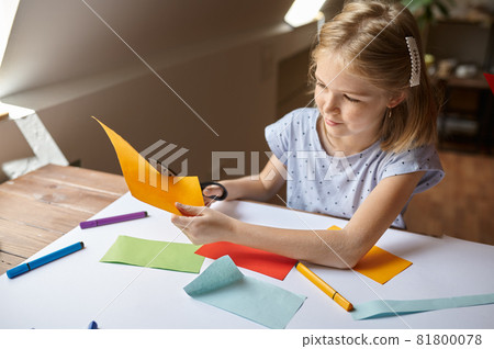 Little girl cuts colored paper, kid in workshop Little girl cuts colored paper, kid in workshop 81800078