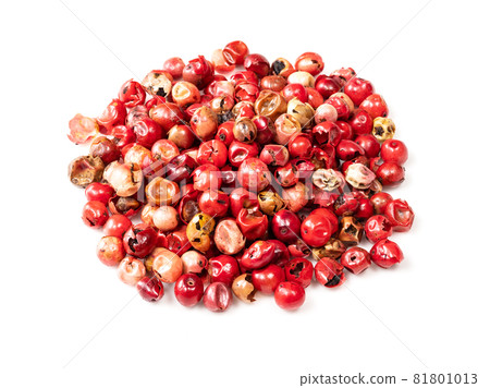 pile of pink peppercorns (Baie rose) closeup on white background 81801013
