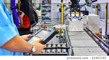 Manager checking and control automated production line cardboard boxes on conveyor belt. parcels transportation system concept 81801387