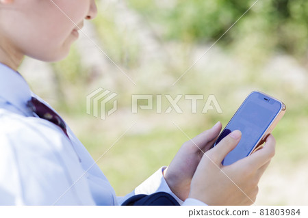 High school girl operating a smartphone High school girl operating a smartphone 81803984