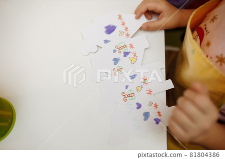 a child in training at home during quarantine makes origami out of paper. children's creativity. hands close up 81804386