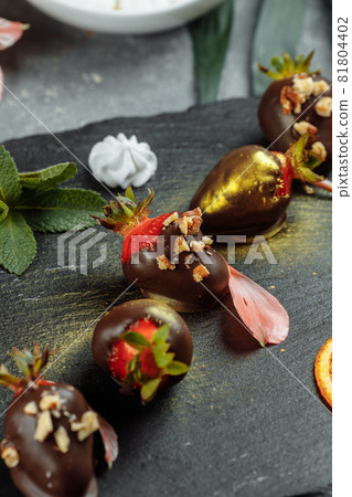 Fresh chocolate covered strawberries on a gray decorative background. Concept for advertising the summer seasonal menu 81804402