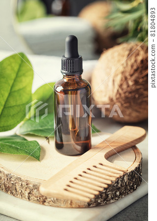 Natural organic coconut oil in Amber glass bottle and wooden hair brush, Natural cosmetics, coconut oil hair treatment concept 81804893