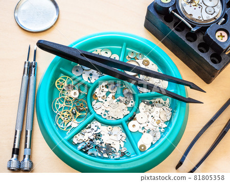 used spare parts for watch repairing close up on table in workshop 81805358