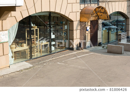 Empty parking space in front of a large shop window Empty parking space in front of a large shop window 81806426