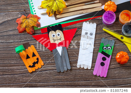 Halloween ghost, pumpkin, mummy and vampire toy gift stics puppets on wooden table. Handmade. Project of children's creativity, handicrafts, crafts for kids. Halloween ghost, pumpkin, mummy and vampire toy gift stics puppets on wooden table. Handmade. Project of children's creativity, handicrafts, crafts for kids. 81807246