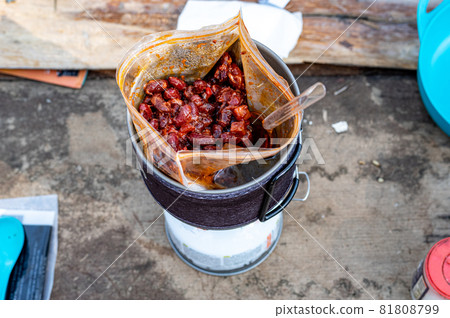 Boiled beans in a bag. Heat the beans on the burner. Tourist food in nature. 81808799