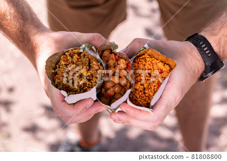 Diverse tourist food. Tourist porridge in a retort package. Chickpea porridge. The tourist is holding various cereals. Diverse tourist food. Tourist porridge in a retort package. Chickpea porridge. The tourist is holding various cereals. 81808800